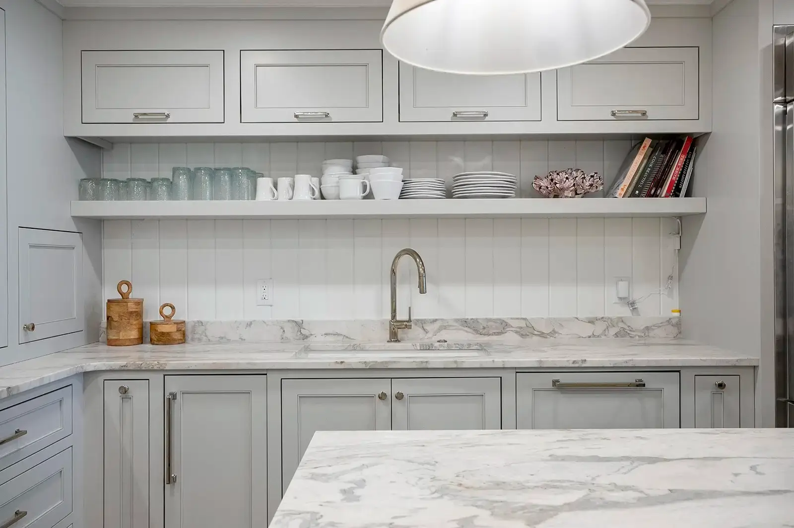 A close-up of the kitchen sink area, showcasing a stylish faucet and backsplash.