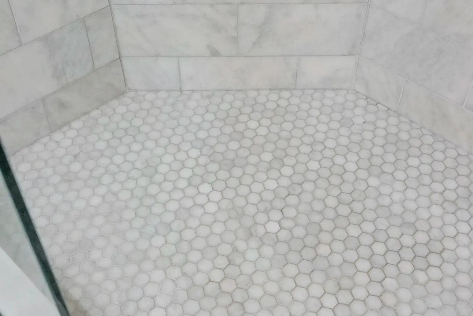 Detailed view of the shower floor, showcasing the tile pattern.