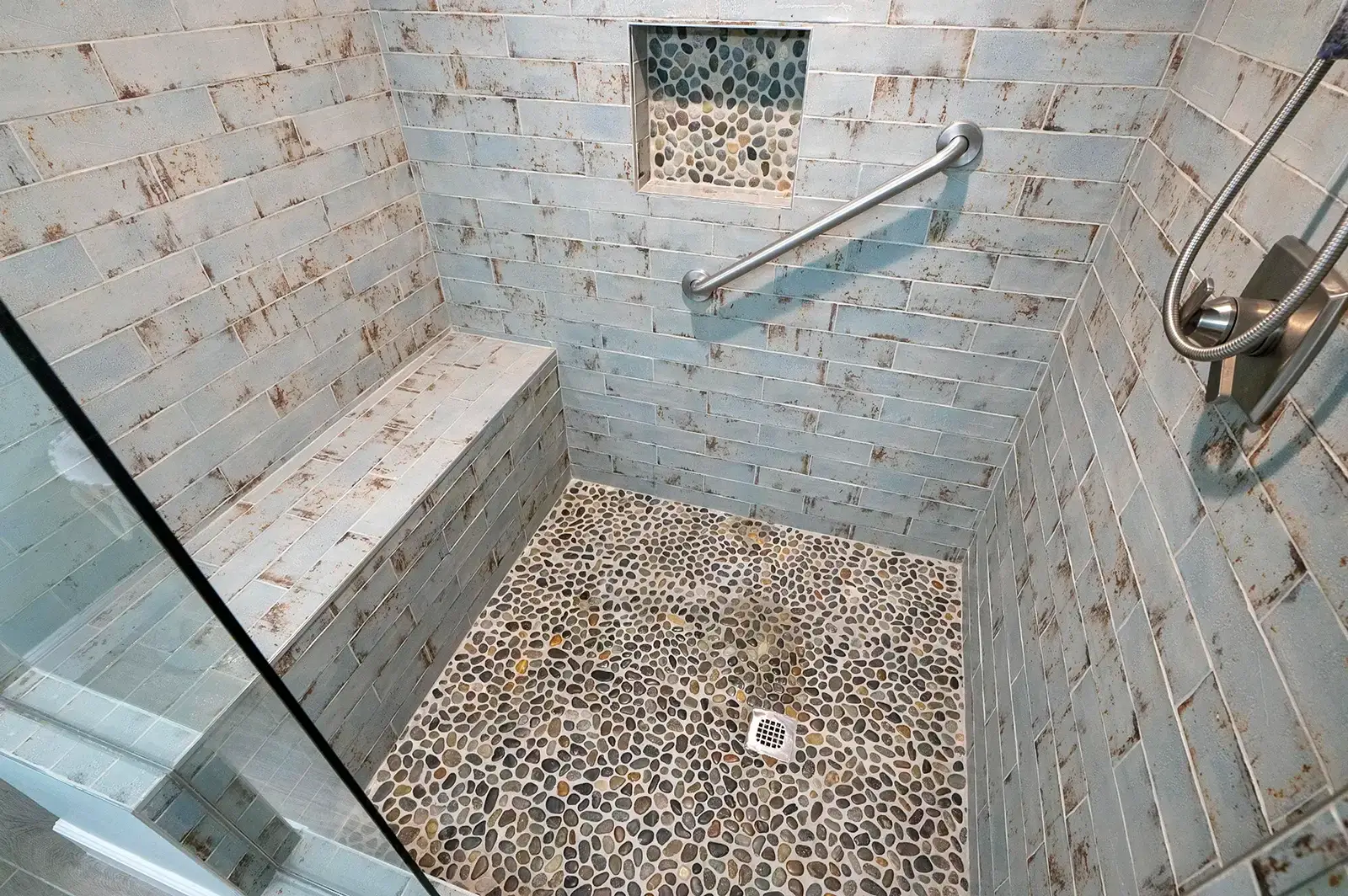 Close-up of the shower area, highlighting the tile work and fixtures.
