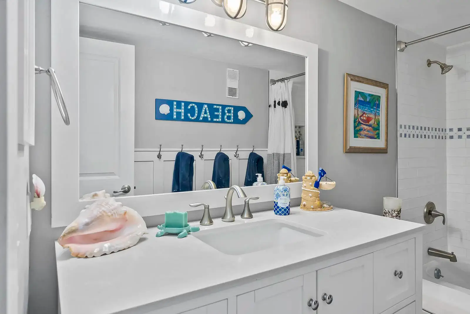A bespoke vanity enhances storage and style in this renovated bathroom.