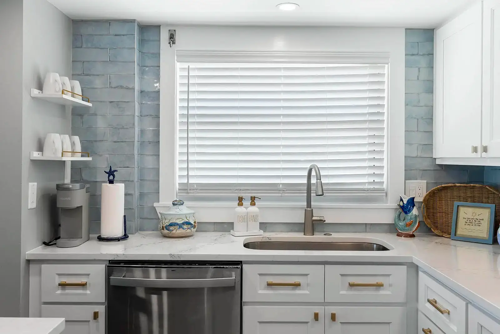 A contemporary sink and stylish backsplash add flair to this Ponce Inlet condo kitchen remodel.