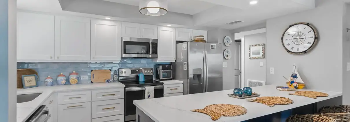 The seamless flow between kitchen and living spaces showcases the open-concept design in this Ponce Inlet condo renovation.