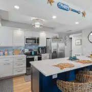 The seamless flow between kitchen and living spaces showcases the open-concept design in this Ponce Inlet condo renovation.