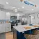 The seamless flow between kitchen and living spaces showcases the open-concept design in this Ponce Inlet condo renovation.
