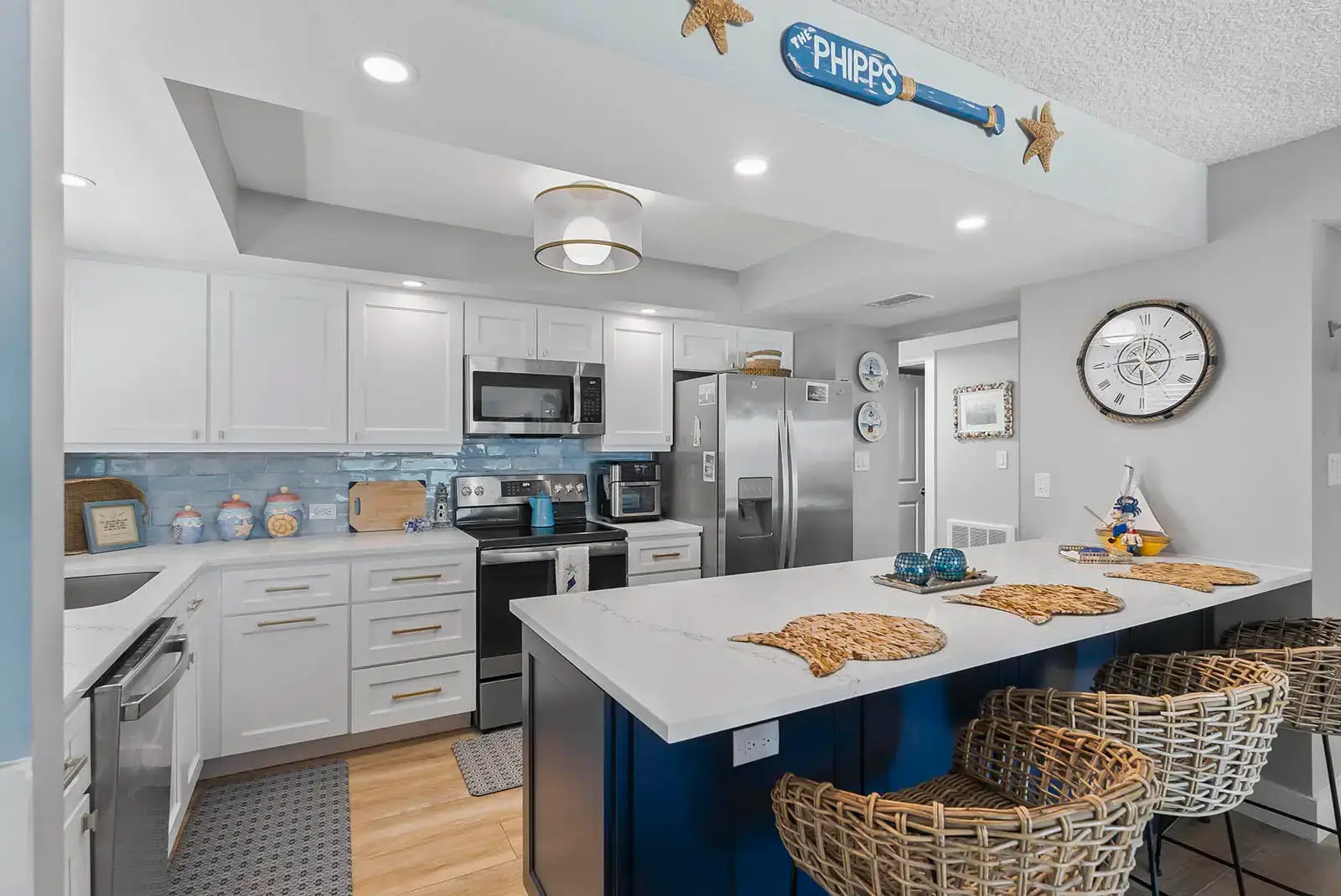 The seamless flow between kitchen and living spaces showcases the open-concept design in this Ponce Inlet condo renovation.